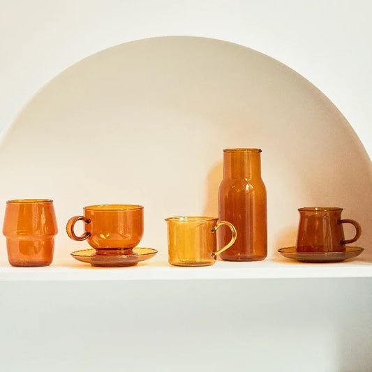 5 CUPS ON A SHELF WITH AN AMBER COLOUR